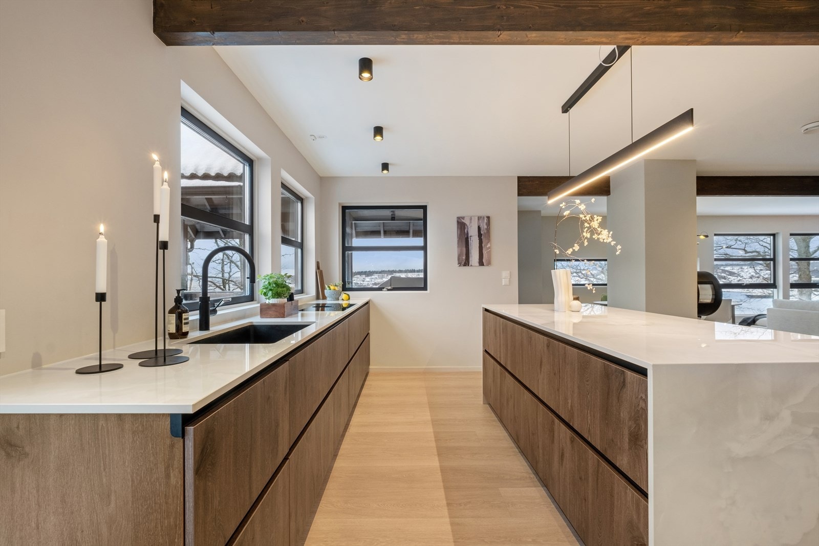 Kjøkkenet har en moderne innredning fra Schmidt (2023), med stilrene, glatte fronter som gir et tidløst uttrykk. Dekton keramisk benkeplate, et meget slitesterkt materiale som tåler varme. Galleribilde