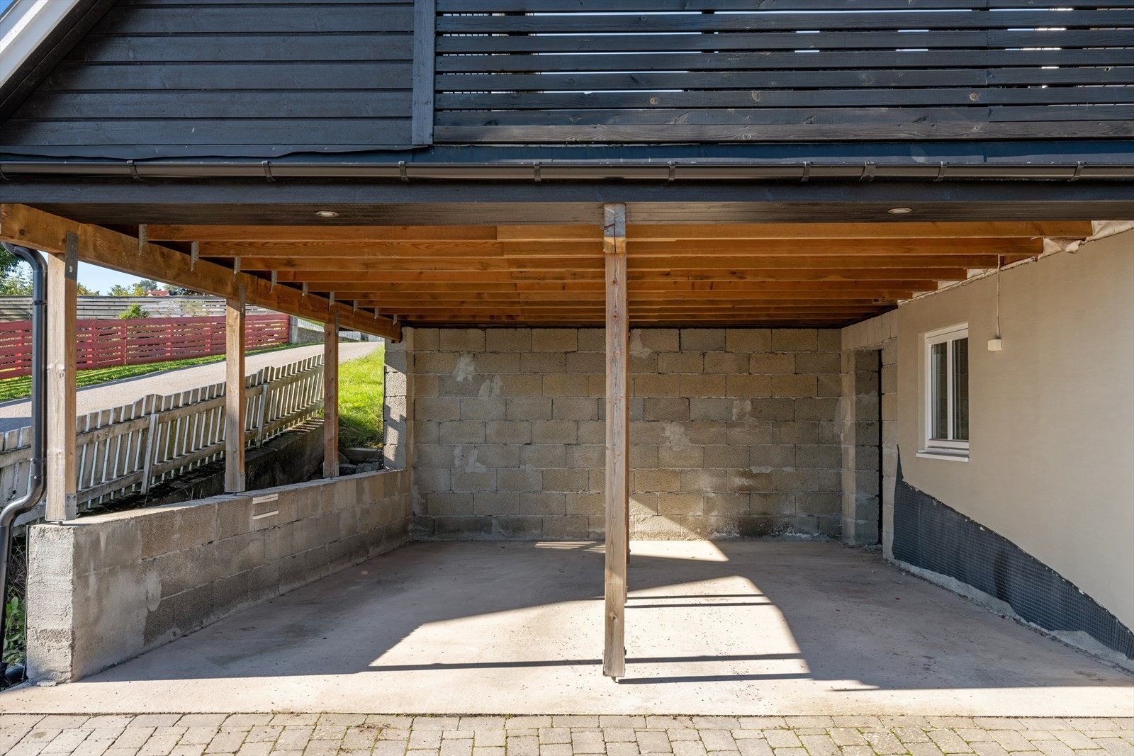 Eiendommen har en romslig og praktisk dobbel carport som gir trygg og værbeskyttet parkering for to biler. Her står kjøretøyene godt skjermet mot regn, snø og sol, og den åpne konstruksjonen sørger for god ventilasjon og minimalt vedlikehold. Galleribilde