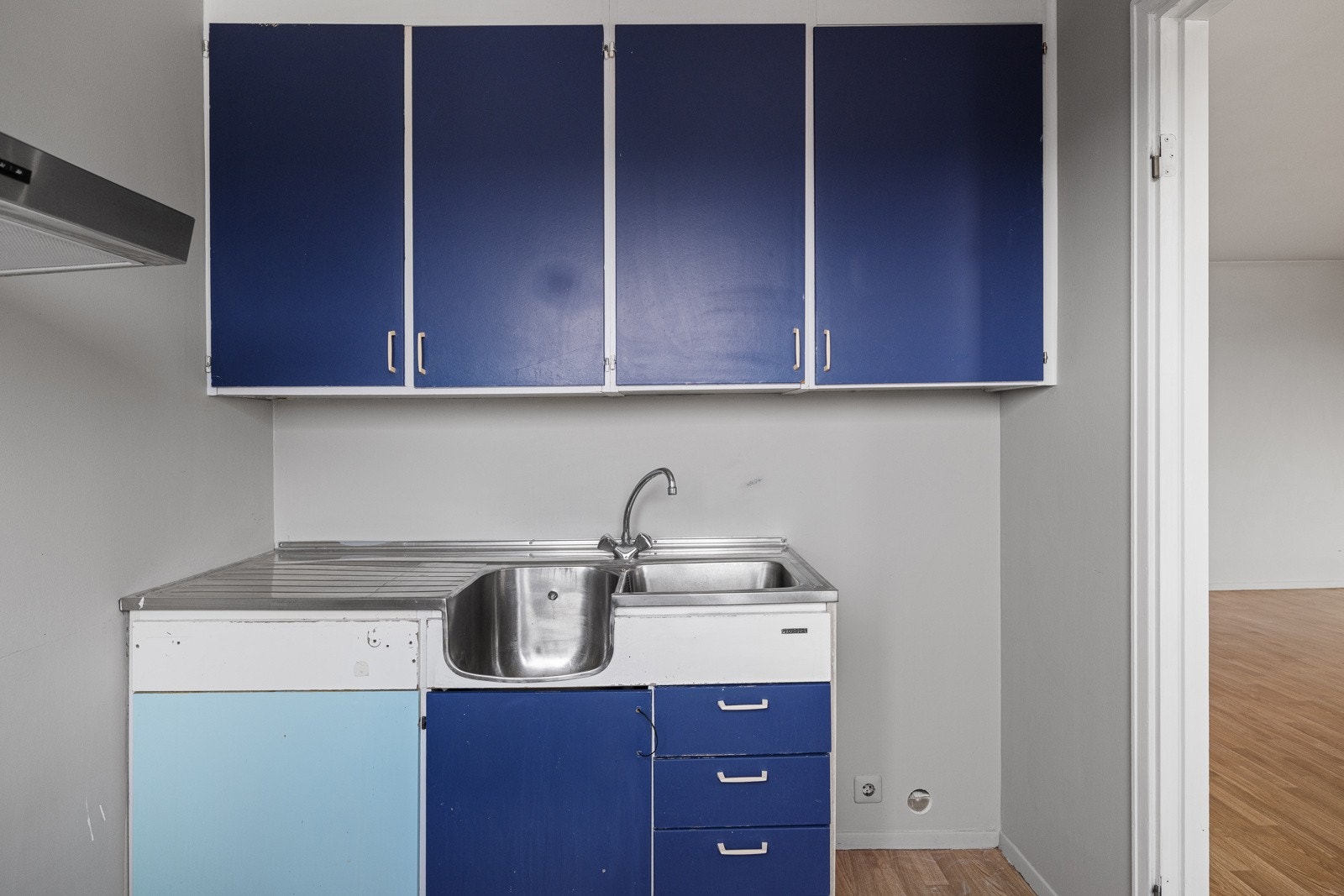 Innredningen har blå glatte fronter, laminert benkeplate og benkebeslag med nedfelt dobbel oppvaskkum. Galleribilde