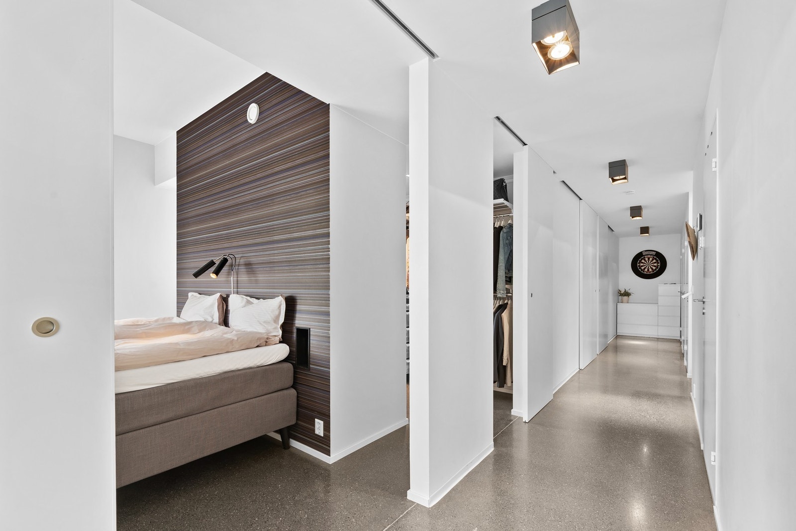 Gang sett mot hovedsoverommet og walk-in garderobe. Betonggulv både i gangen og på hovedsoverommet - noe som skaper et helhetlig og lekkert uttrykk. Galleribilde