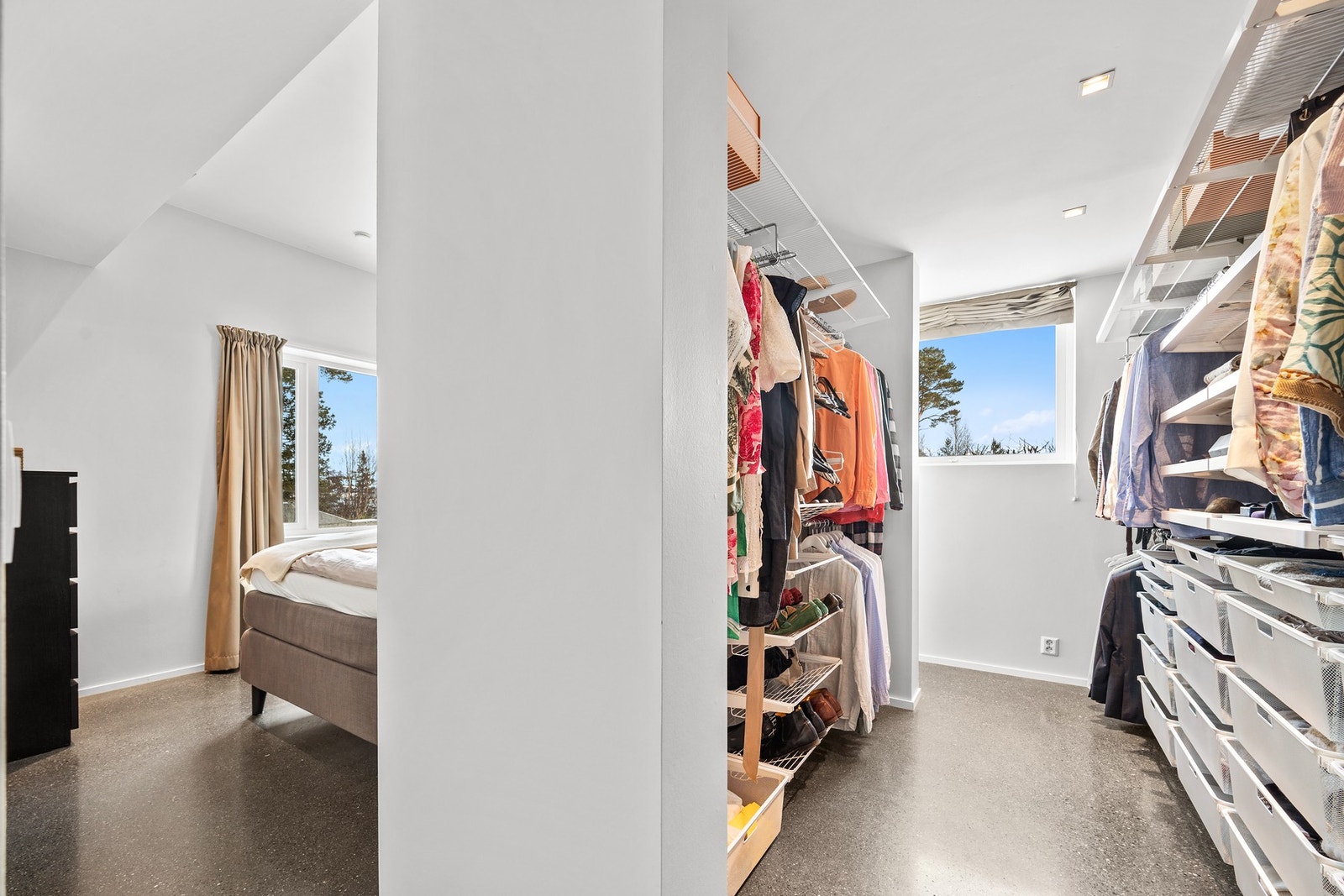 Praktisk og romslig walk-in garderobe, med tilgang fra begge sider av senga på motsatt side av veggen. Galleribilde