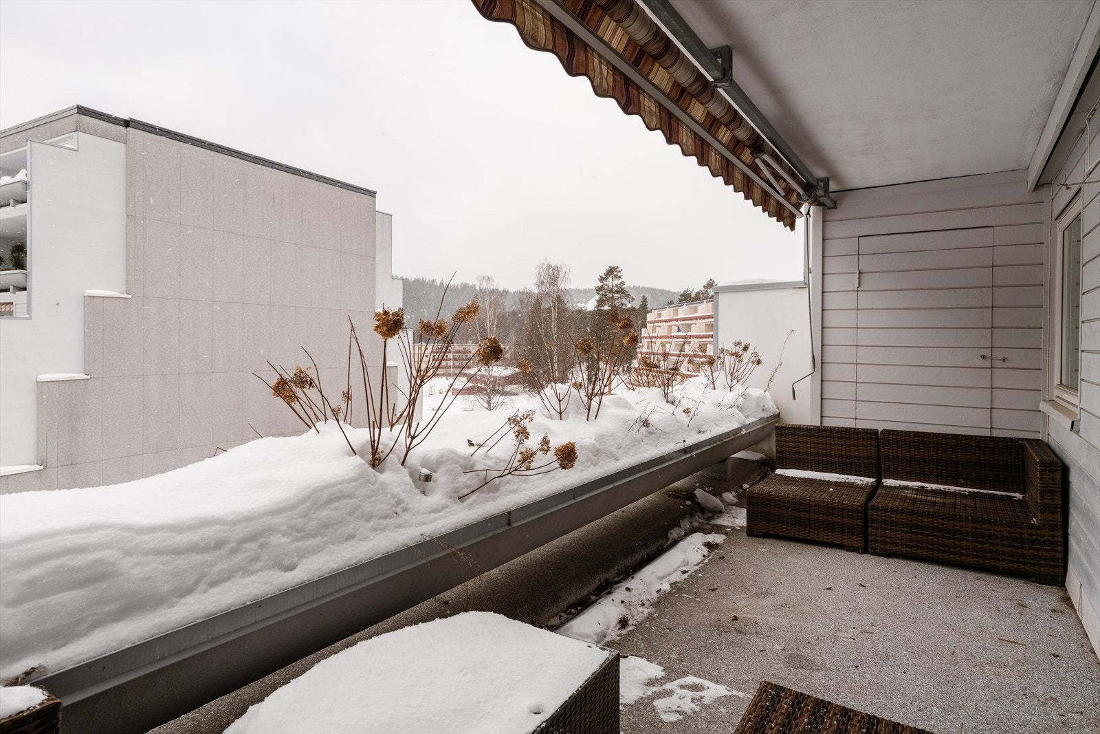 Balkongen har overbygg og markise, samt støpte blomsterkasser for et frodig uttrykk. Galleribilde