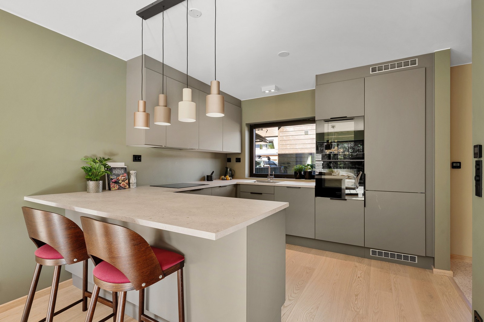 Her får du et funksjonelt HTH-kjøkken med gode arbeidsflater og en utvidet kjøkkenbenk som åpner for en praktisk sitteplass/barløsning Galleribilde