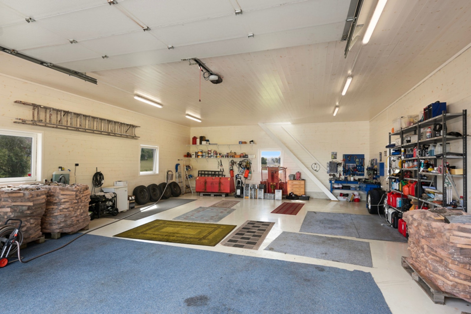 Rikelig med plass til verksted og oppbevaring i hyller langs veggen Galleribilde