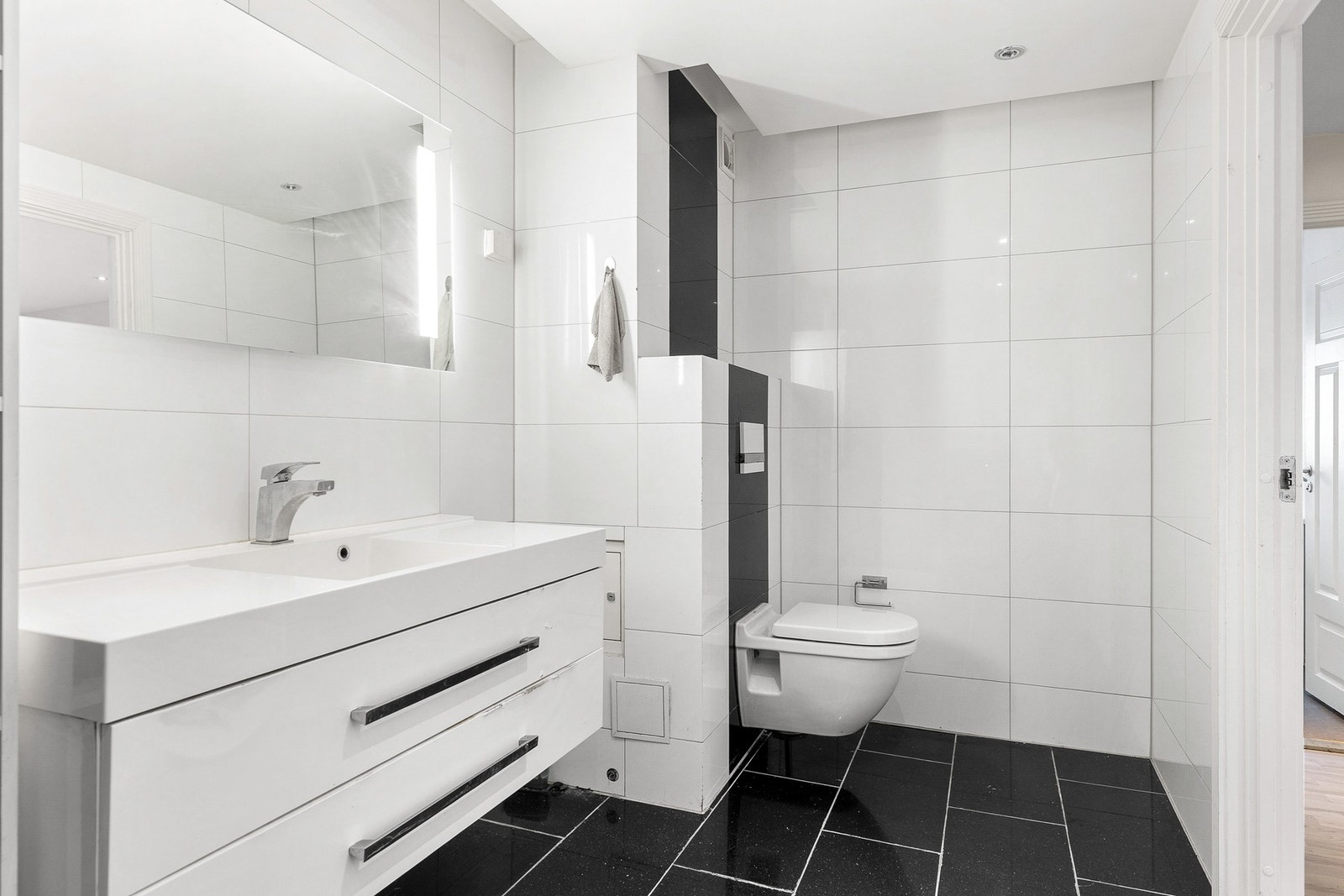 Badet har flislagte overflater med opplegg for vaskemaskin. Galleribilde