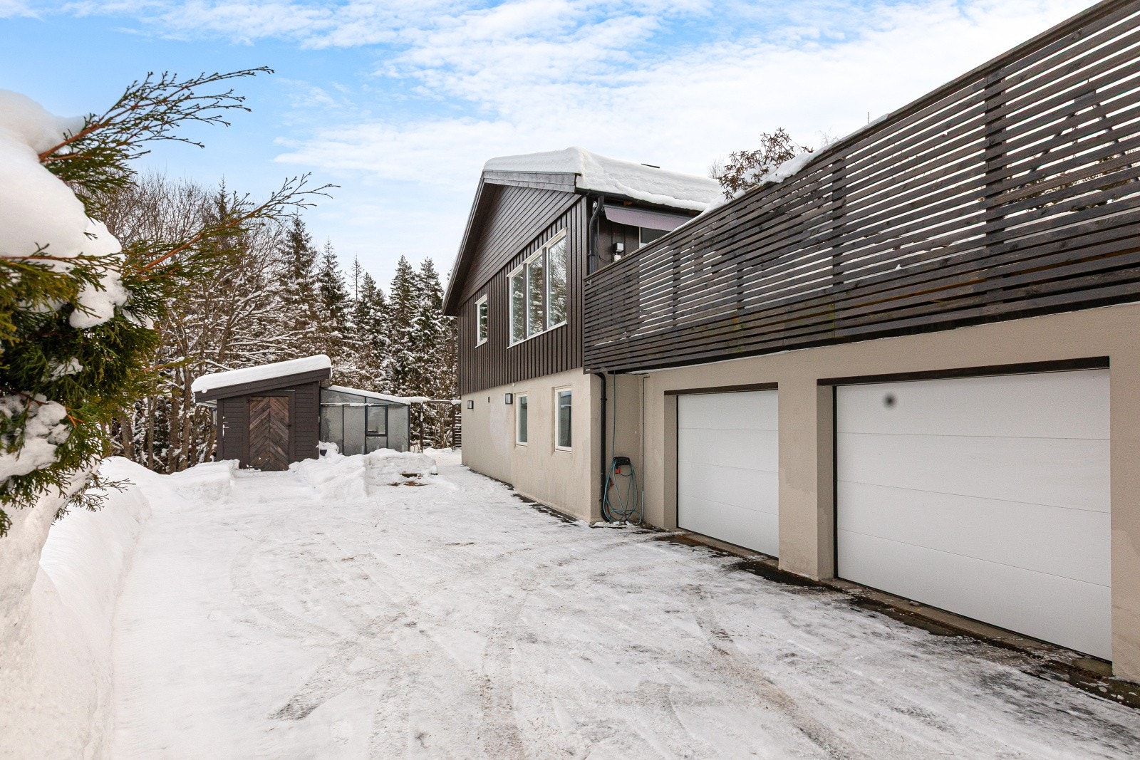 Eiendommen har en integrert dobbelgarasje med elektriske porter, og det er installert elbillader - en praktisk og moderne løsning for en enkel hverdag. Galleribilde