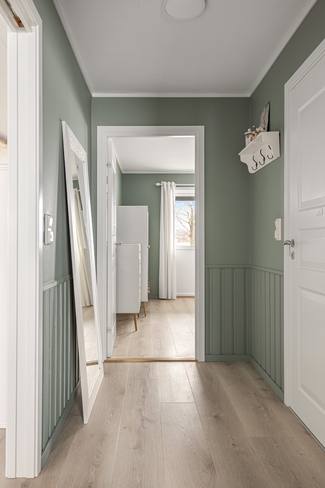 Gangen fra stuen til soverommet i 1. etasje er grønnmalt og har samme gulv som i oppholdsrommene. Galleribilde
