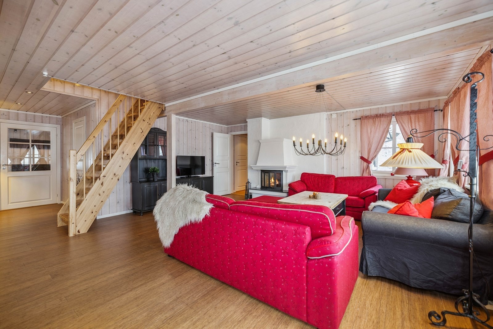 Tretrappen fører opp til en romslig hems med ekstra soveplasser og en egen stue. Galleribilde