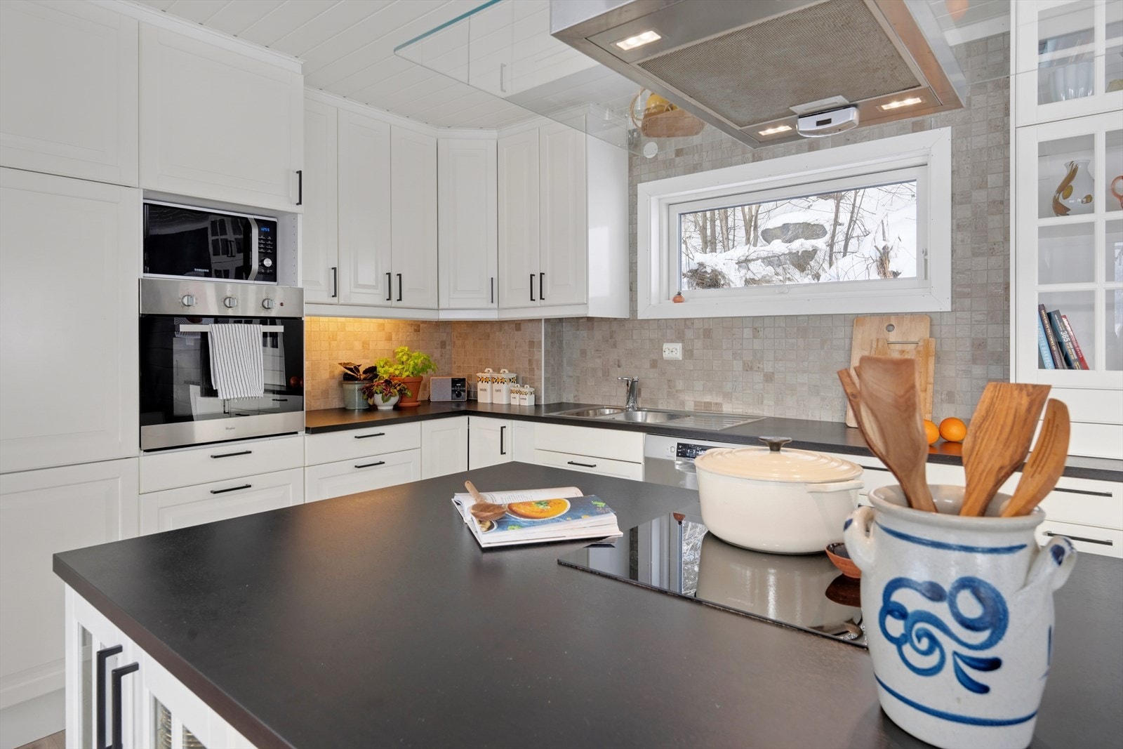 Kjøkkenøy med induksjonstopp gir ekstra plass til matlaging og oppbevaring. Galleribilde