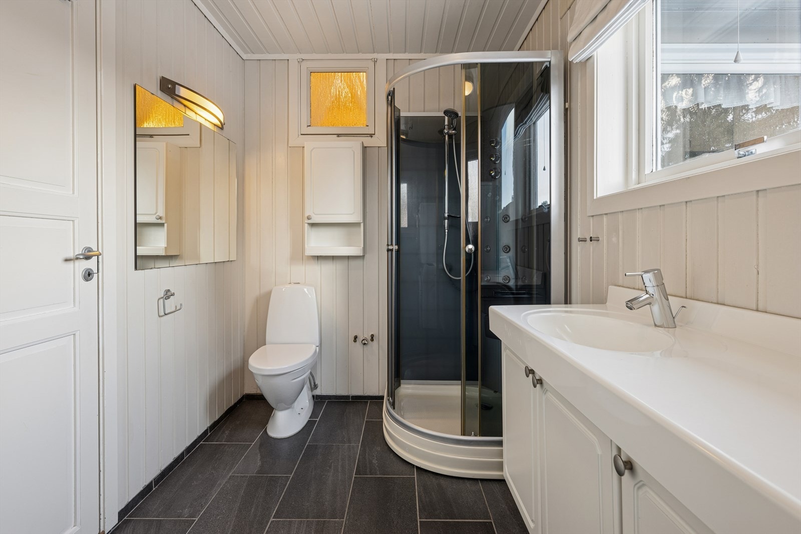Bad/vaskerommet har dusjkabinett, toalett og opplegg for vaskemaskin og er del av påbygg som ikke er omsøkt. Galleribilde