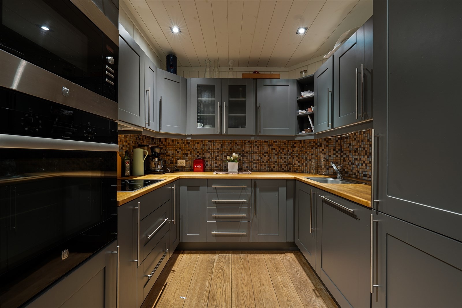 Kjøkken med grå fronter og eik benkeplate. Galleribilde