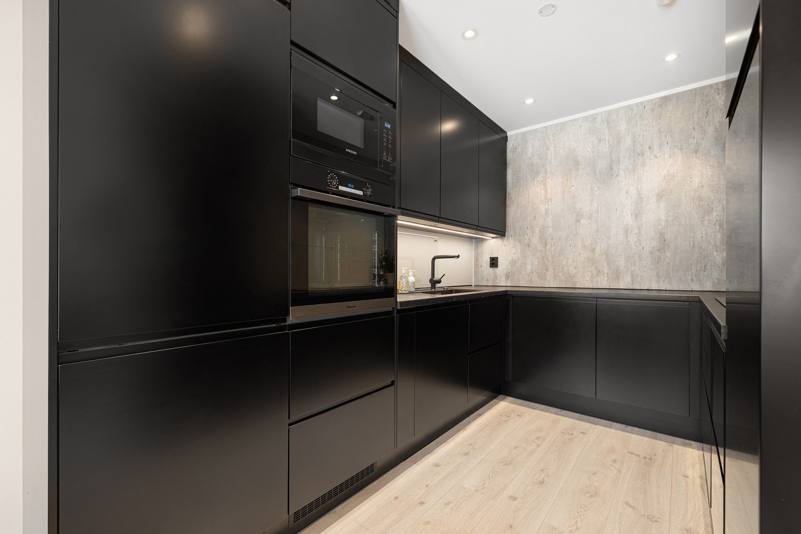 Kjøkkenet ble pusset opp i 2021 og er innredet med plane fronter og benkeplate er av laminat. Overflater og innredningen på kjøkkenet har fått tilstandsgrad 1 av takstmann. Galleribilde