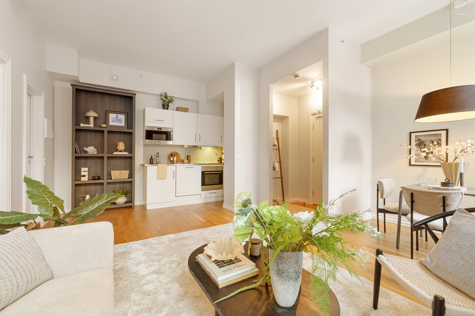 Kjøkkenet har hvite, profilerte fronter og en 28 mm tykk, grålaminert benkeplate. Galleribilde