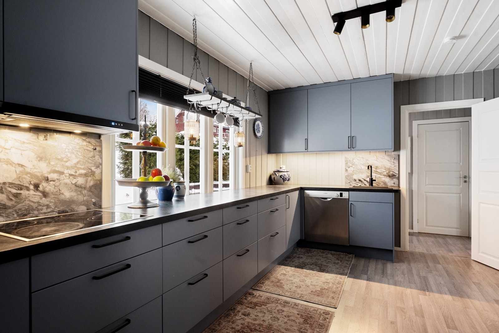 Laminert benkeplate med nedfelt vaskekum og platetopp, samt glassplate på vegg over arbeidsområdet for et stilrent uttrykk. Galleribilde