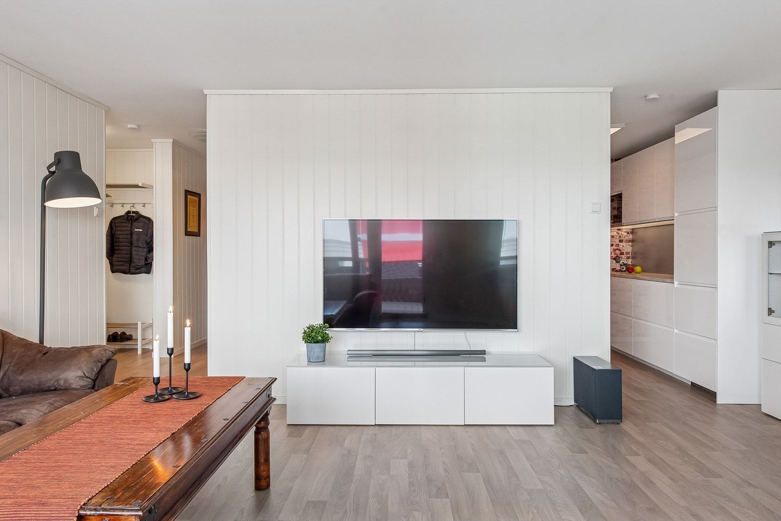 Stuen er et sentralt rom med gjennomgående laminatgulv og malte panelplater på veggene. Galleribilde