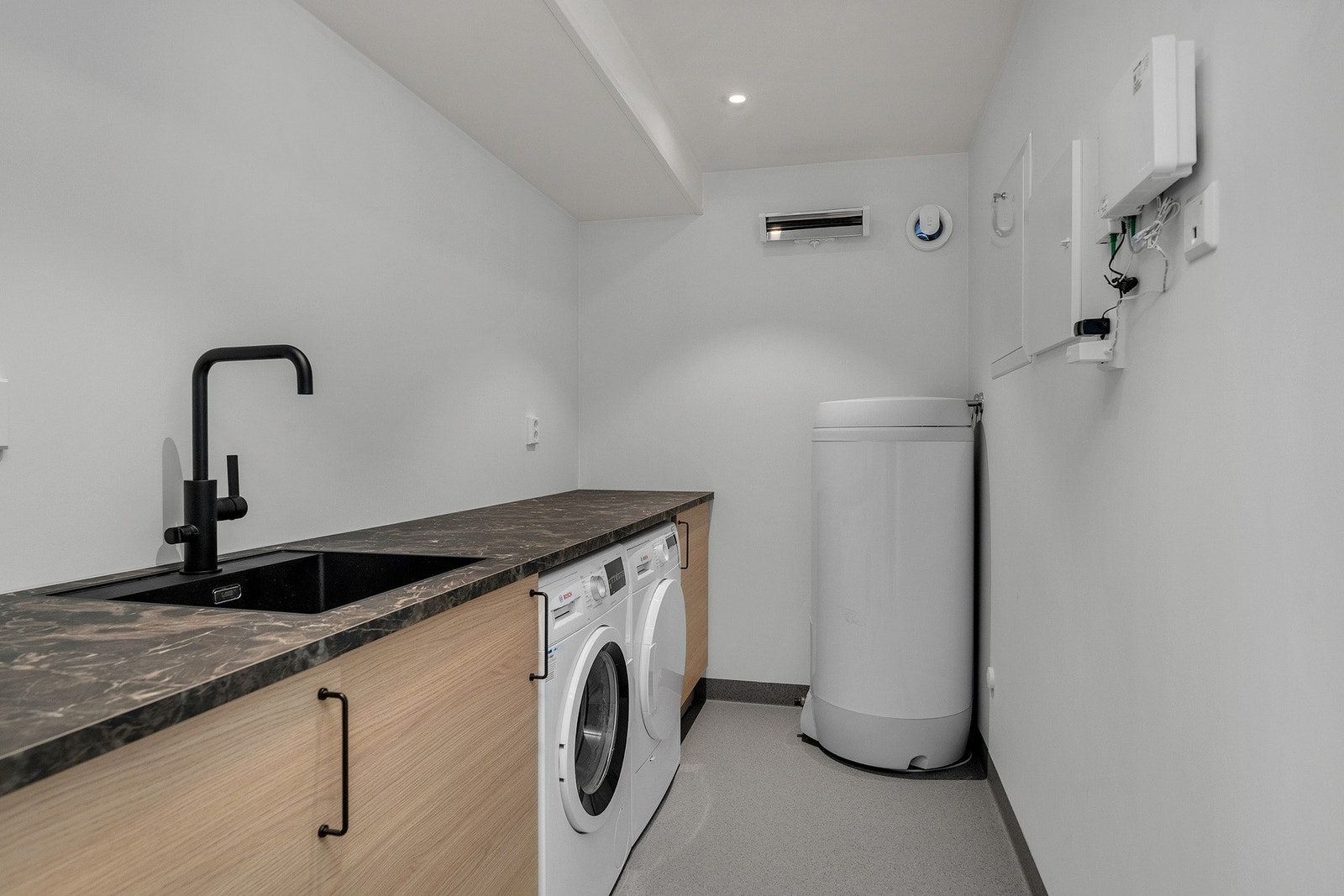 Separat vaskerom har innredning med skap og benkeplass, samt nedfelt servant og opplegg for vaskemaskin - Bereder, rør-i-rør skap og el-tavle er plassert på vaskerom Galleribilde