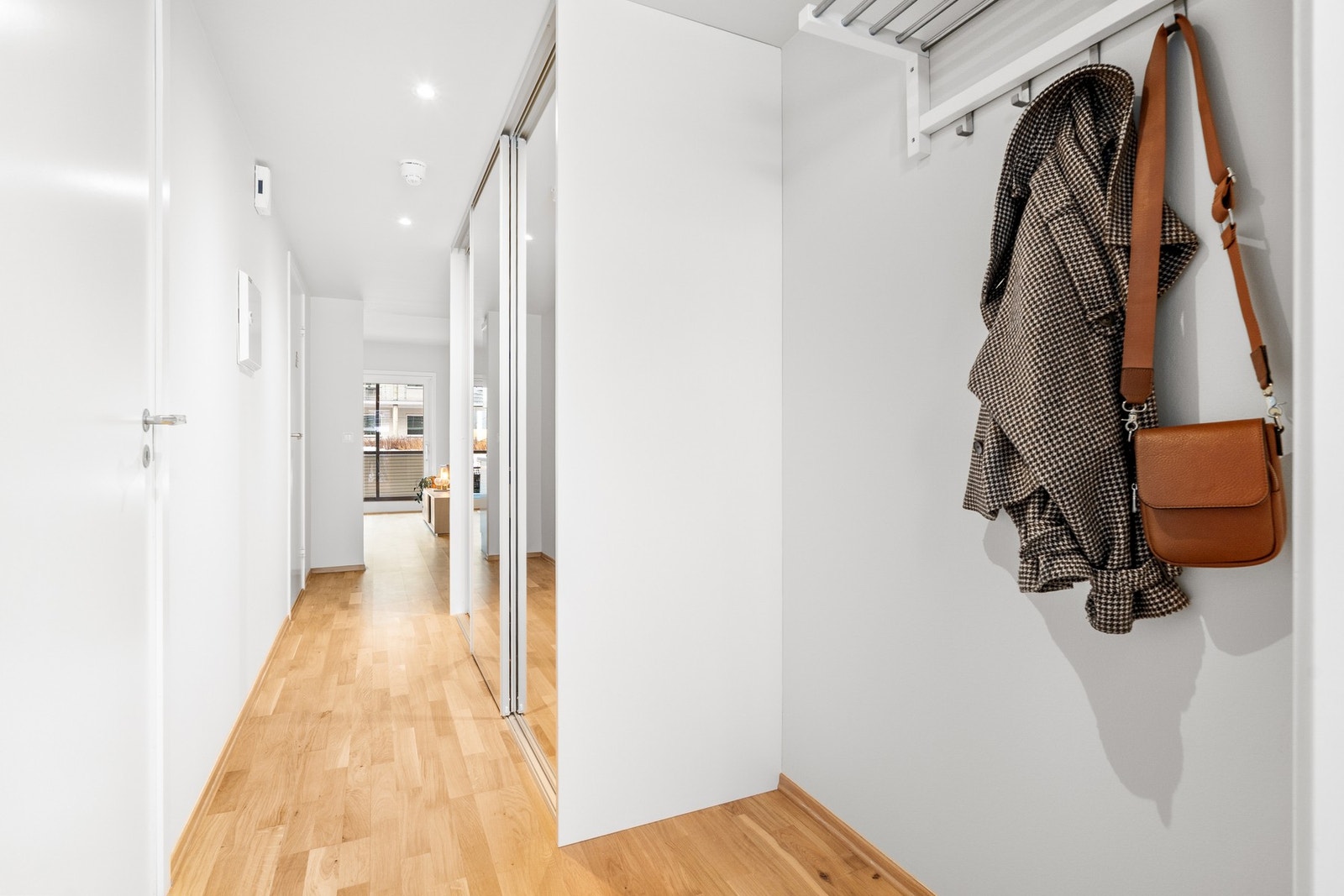 Lys gang med stor og praktisk skyvedørsgarderobe. Galleribilde