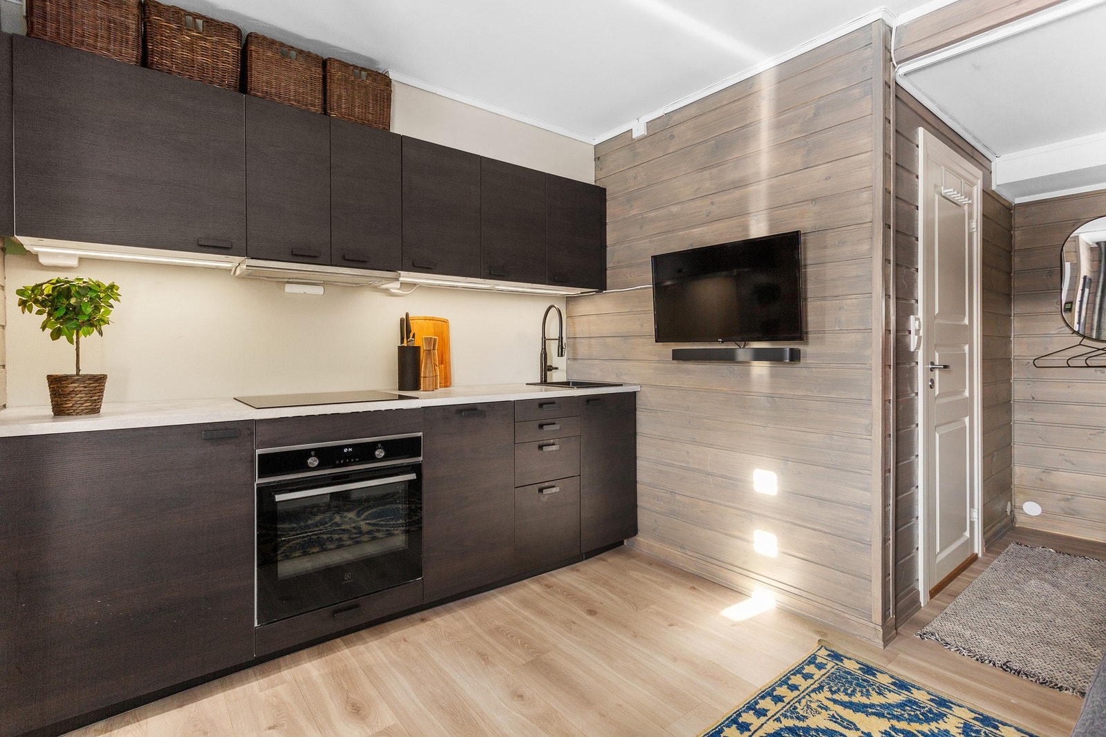 Kjøkkeninnredningen har slette fronter og laminat benkeplate Galleribilde