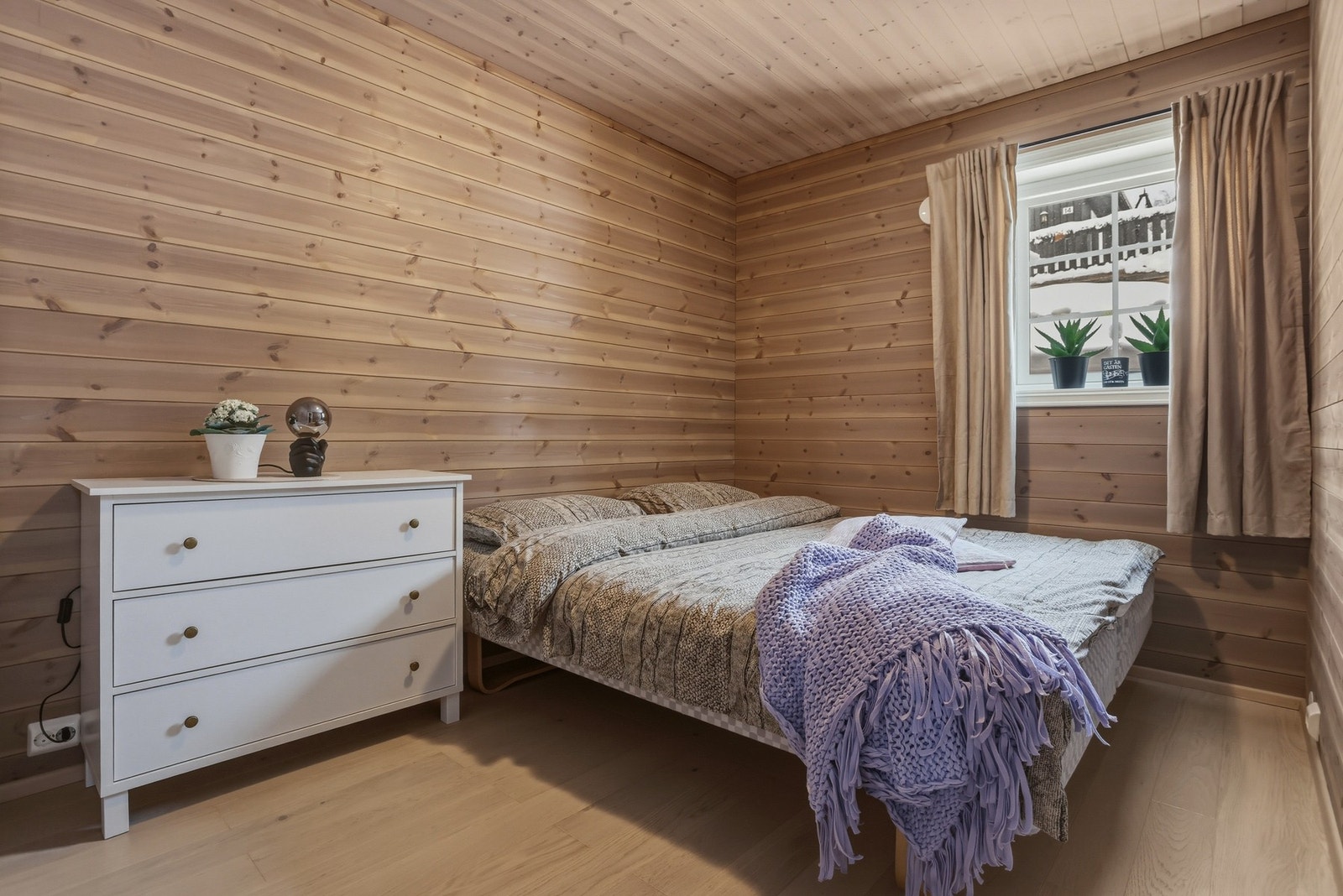 Hovedsoverom innredet med dobbeltseng og kommode Galleribilde