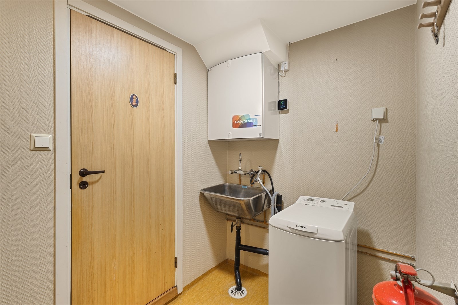 Vegg-i-vegg finner man et praktisk separat vaskerom med utslagsvask, opplegg for vaskemaskin og ventilasjonsanlegg. Galleribilde