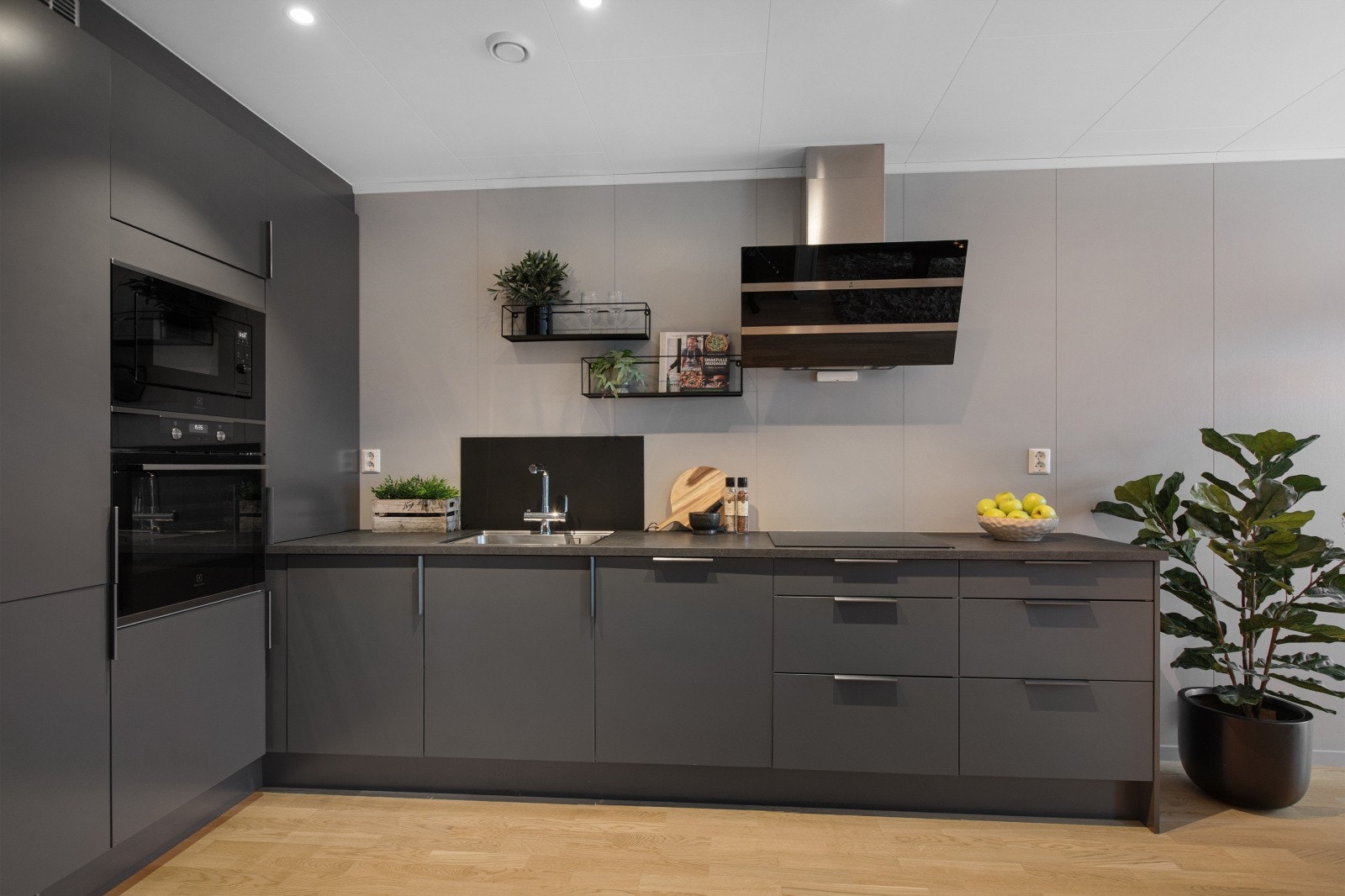 Moderne innredning fra Sigdal kjøkken med slette fronter og laminat benkeplate med nedfelt benkebeslag og ett-greps blandebatteri. Galleribilde