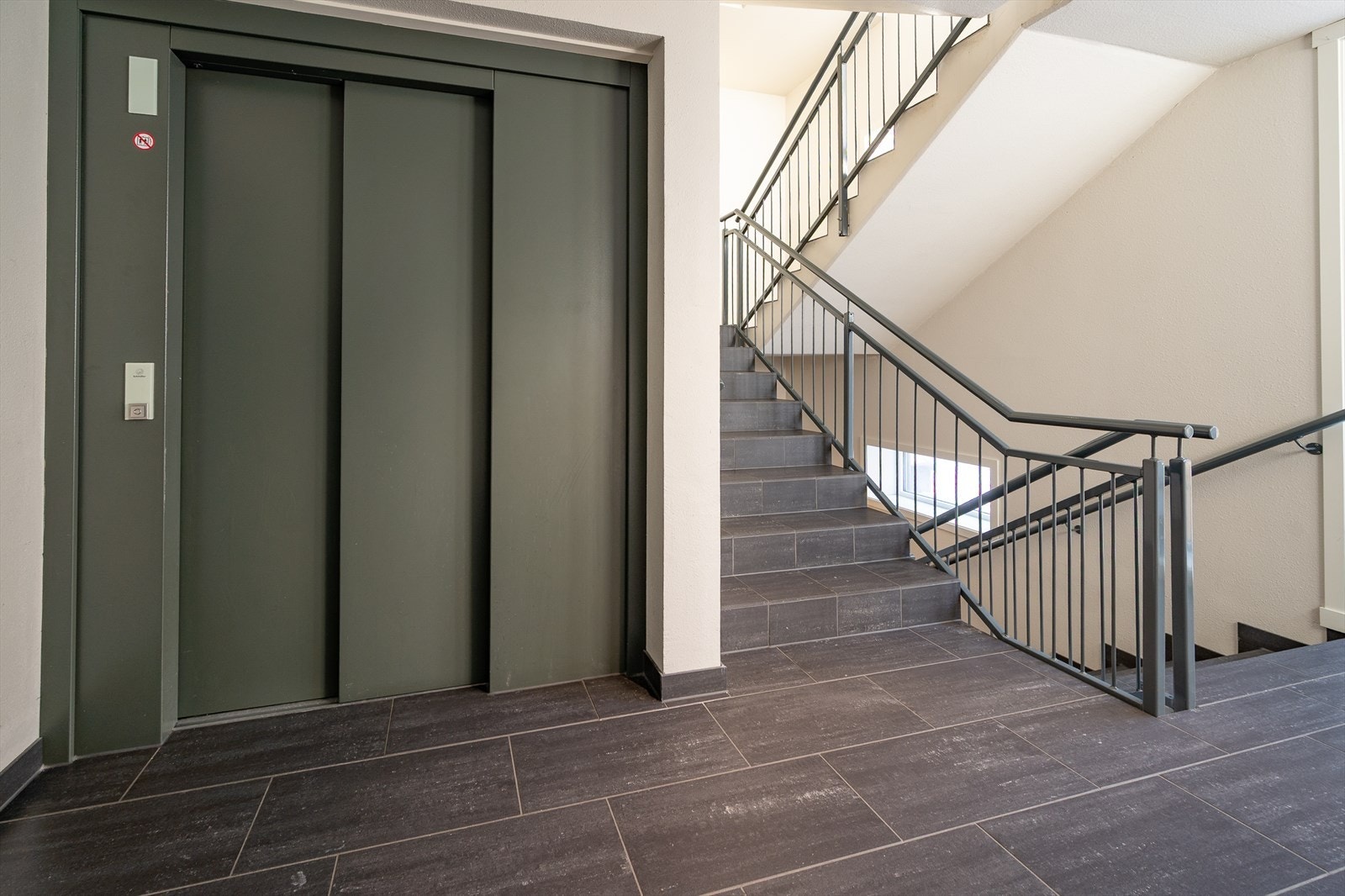 Ryddige fellesareal med heis til leilighetens etasje Galleribilde