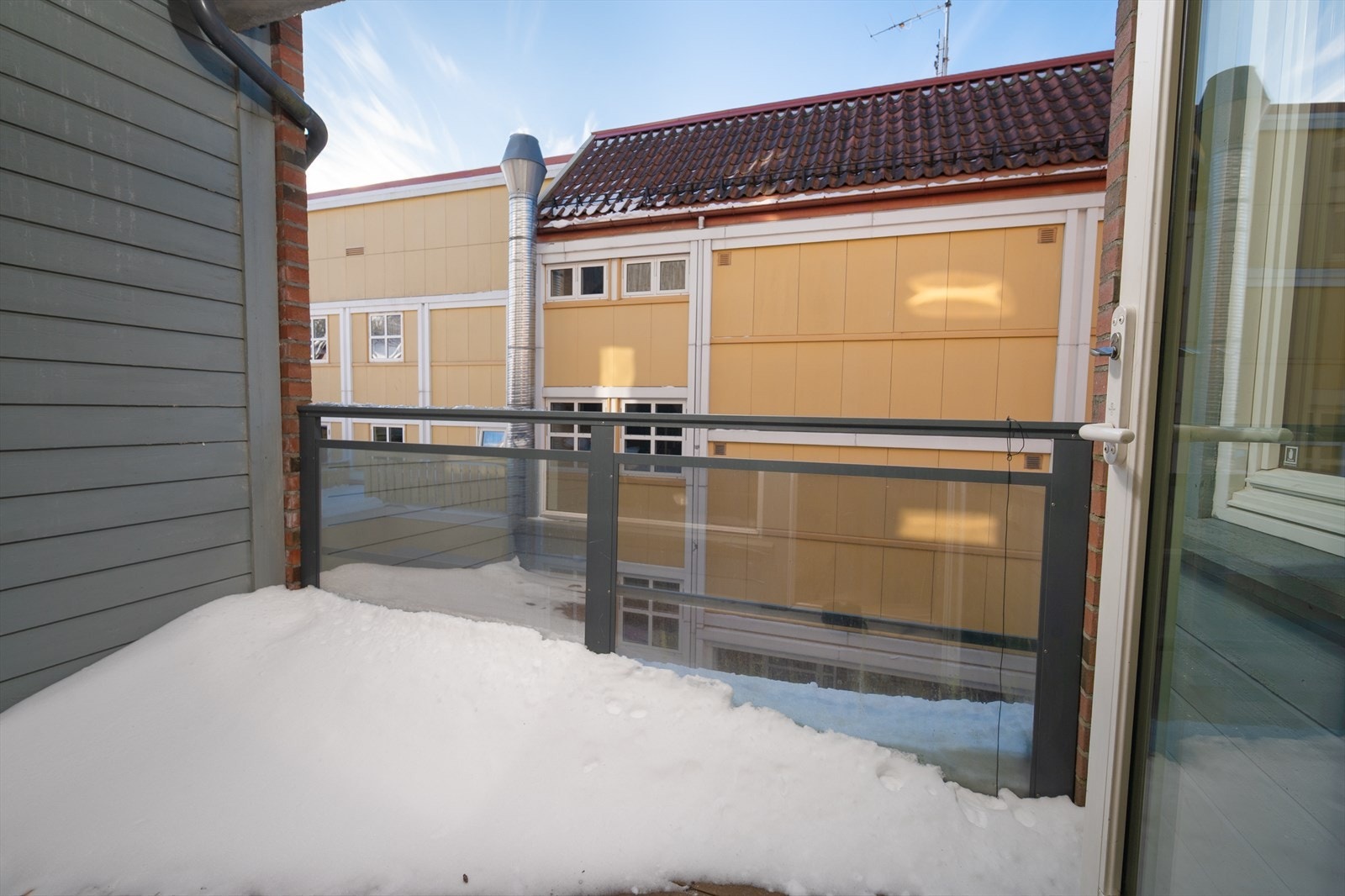 Balkongen er omtrent 5 kvm med takoverbygg og rekkverk i glass Galleribilde