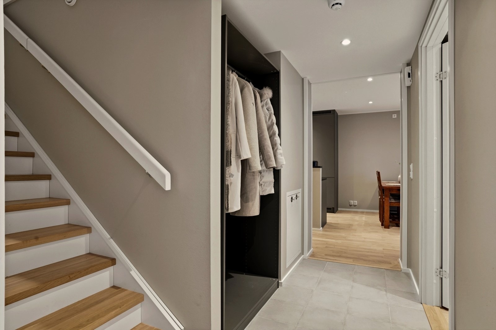 Man kommer inn i den flislagte entréen med garderobe for oppbevaring av yttertøy og sko, og trapp opp til leiligheten toppetasje. Galleribilde