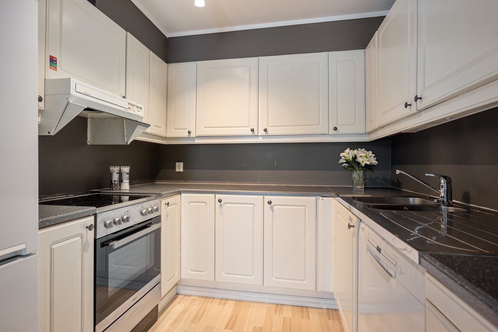 Kjøkkenet har en praktisk åpen løsning mot stuen, med innredning med profilerte fronter. Galleribilde