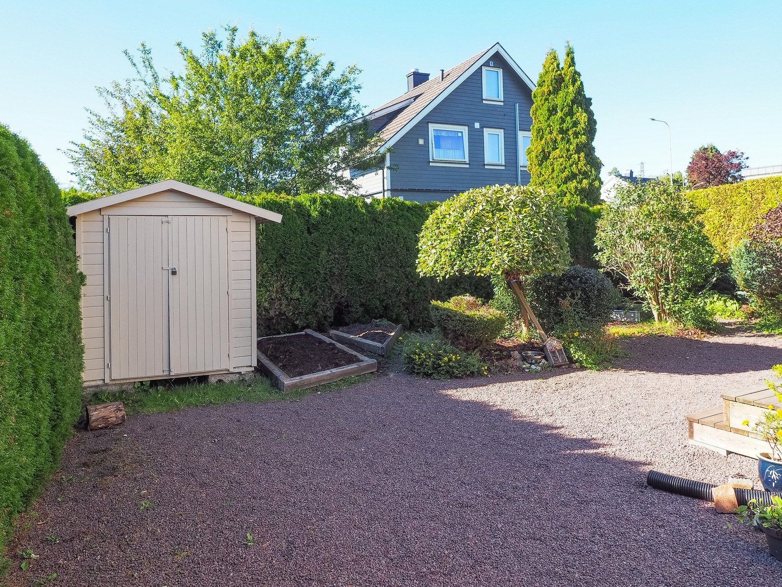 Mens her er et sommebilde av hagen mot vest med kjøkkenhagen Galleribilde