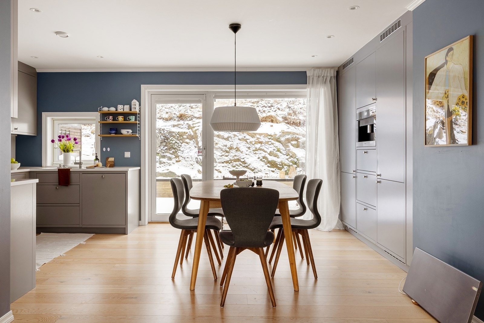 Her samles familie og venner rundt spisebordet. En lun og innbydende sone som kombinerer funksjon og trivsel. Galleribilde