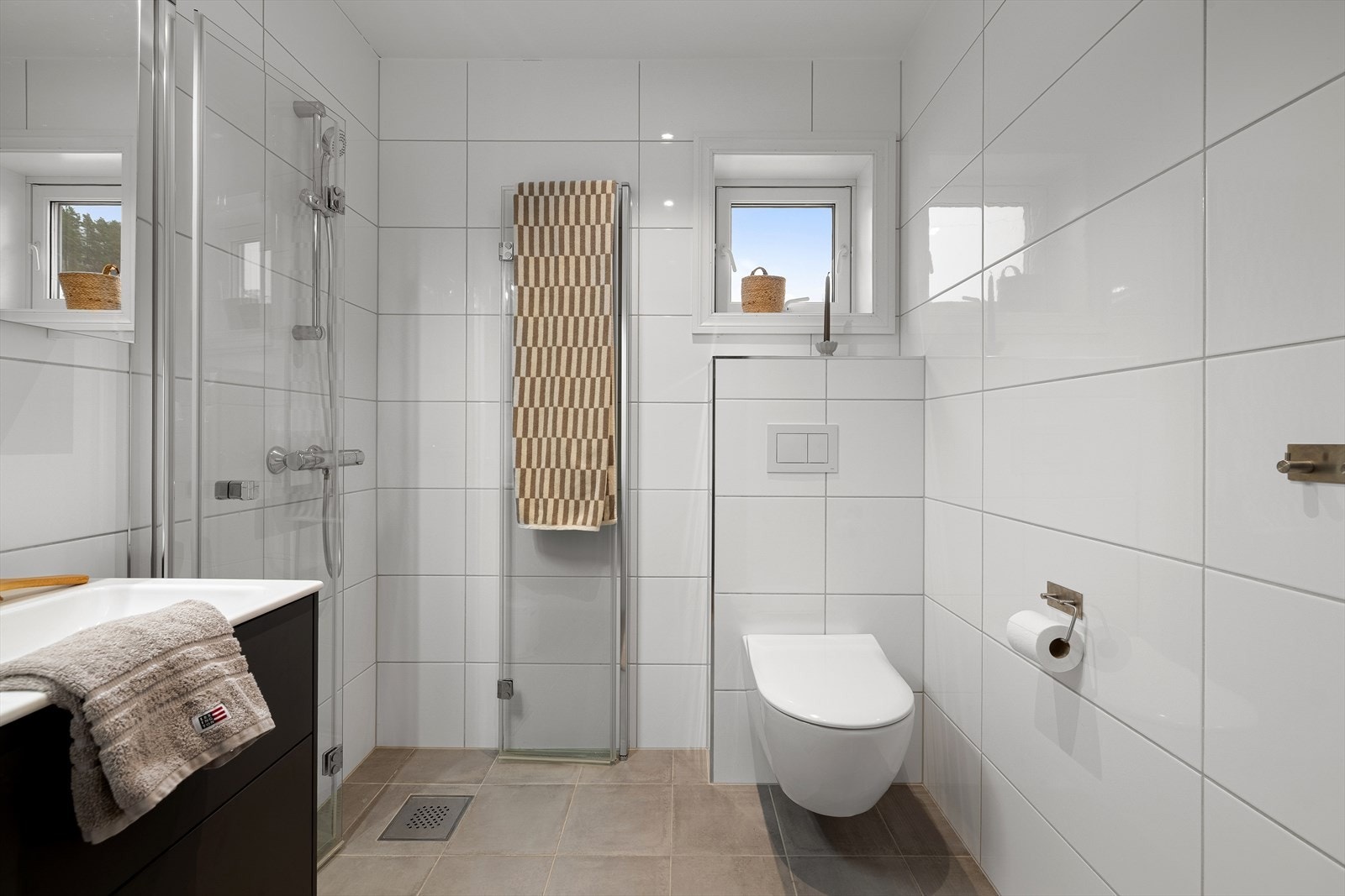 Badet i 2. etasje ligger mellom de to soverommene og har flislagte overflater og moderne innredning. Galleribilde