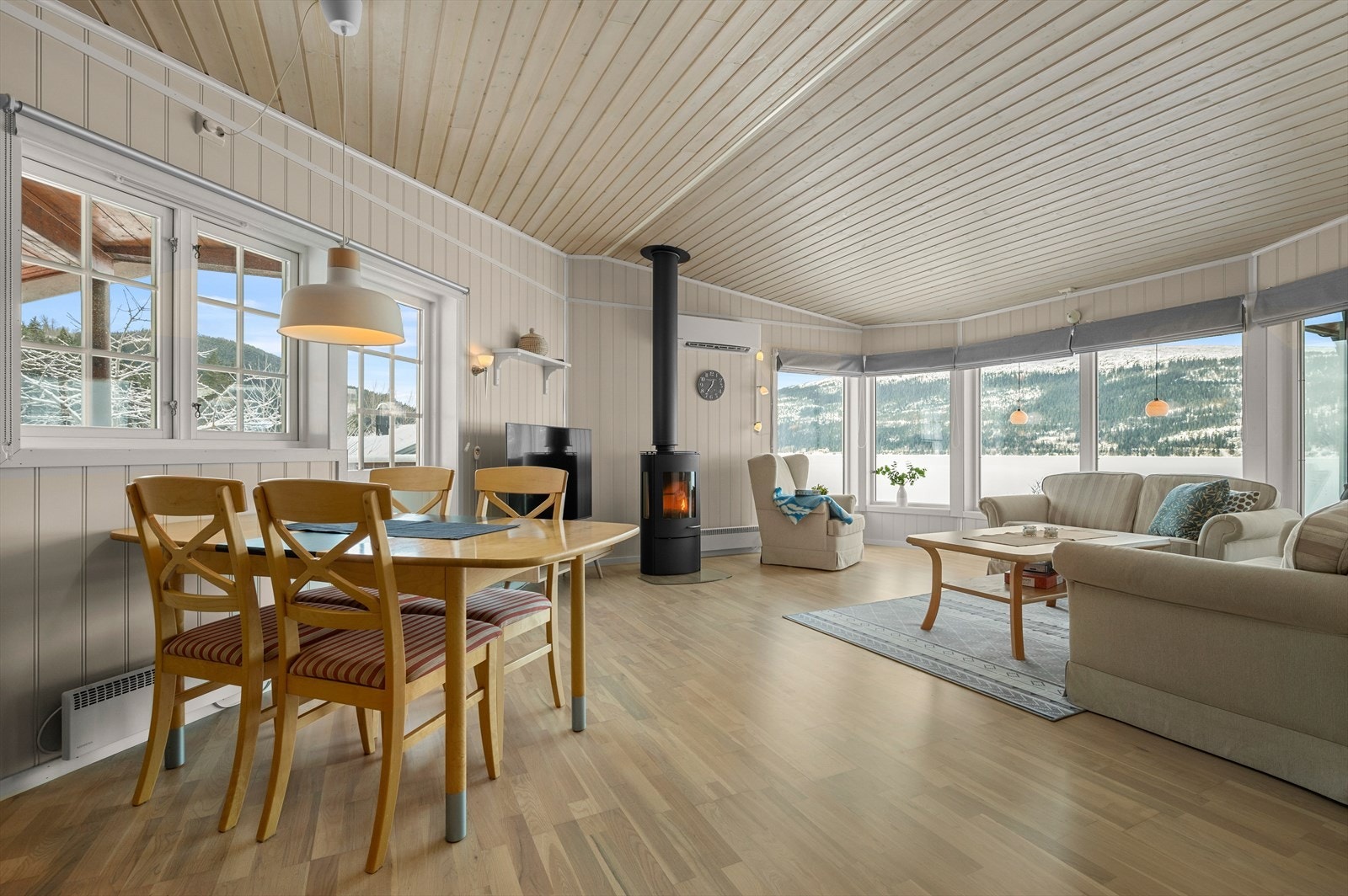Allrommet har en lun atmosfære med både peisovn og en varmepumpe fra 2022. Galleribilde
