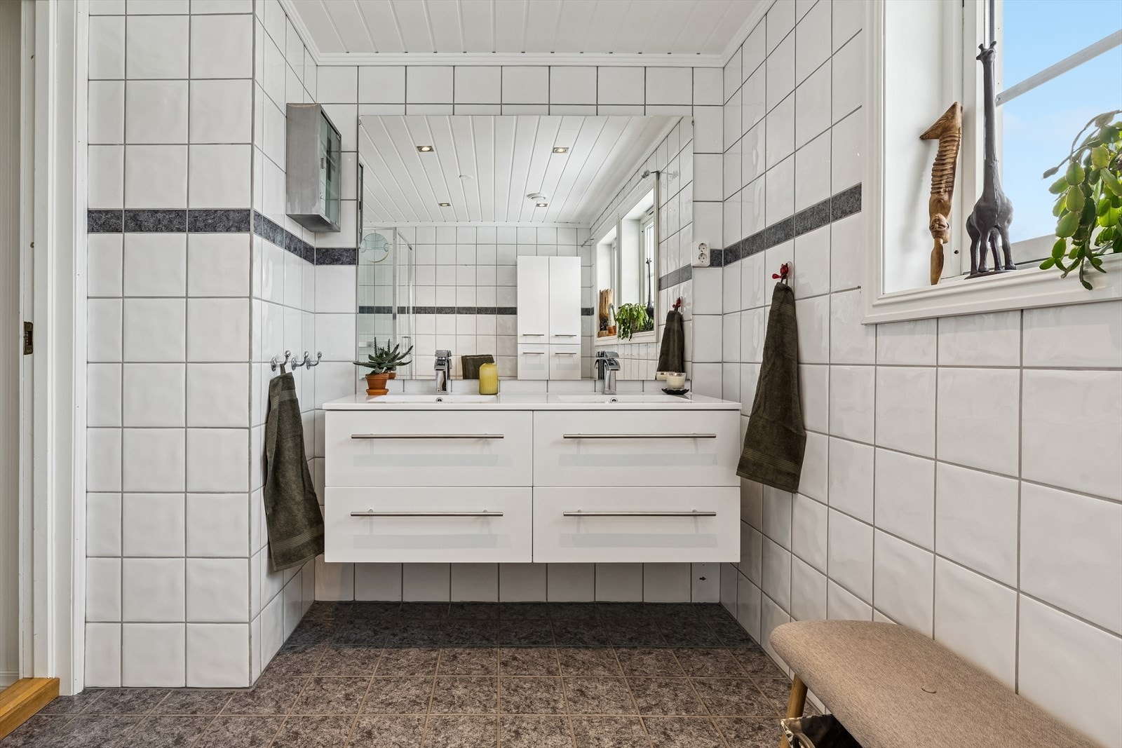 Innredningen inkluderer en heldekkende dobbel servant og to praktiske høyskap for oppbevaring. Galleribilde