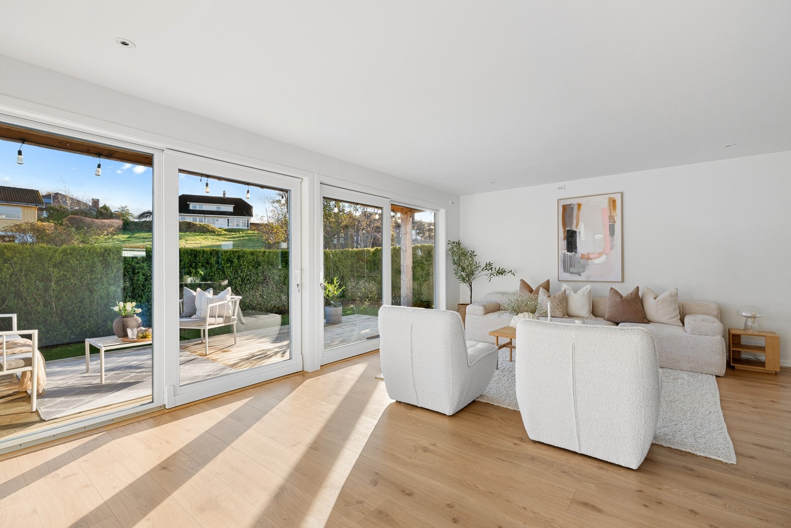 De store skyvedørene fra begge stuene gir utgang til terrassen og hagen, og skaper en sømløs forbindelse mellom inne- og uterom. Galleribilde