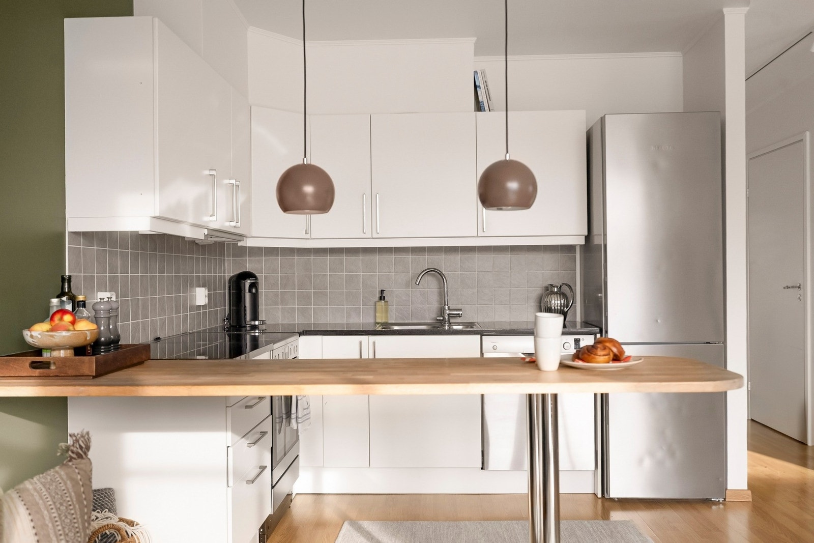 Benkeplate på kjøkkenet er av tre på halvøyen, og stein på resterende. Galleribilde