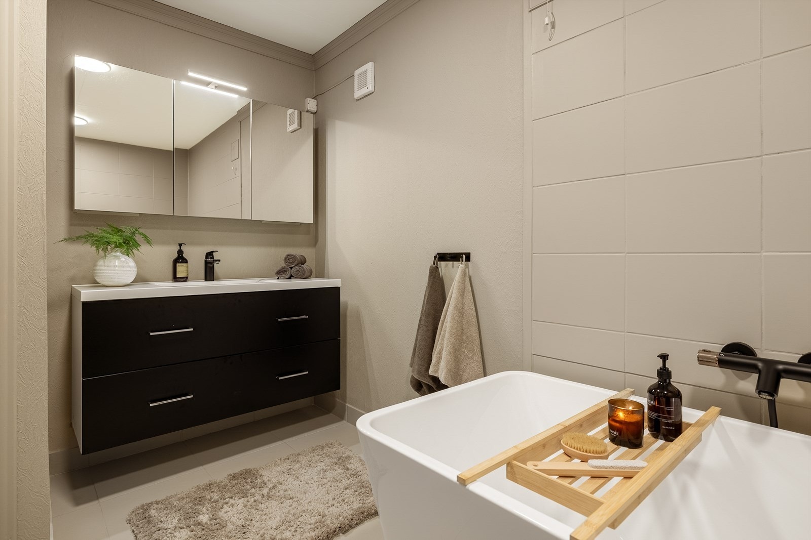 Badet i 1. etasje er romslig og praktisk utformet med et areal på ca. 7 m². Her er det god gulvplass og en funksjonell innredning med badekar. Galleribilde