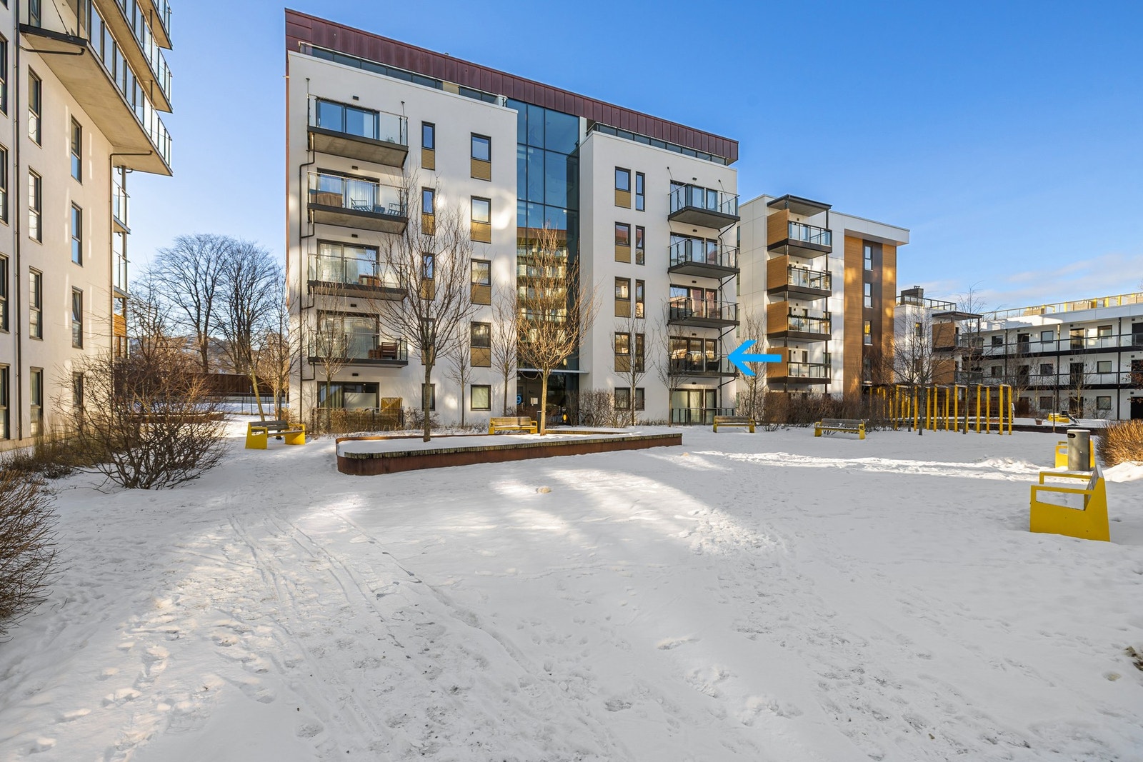 Leilighetsbygget ble oppført i 2017 og leiligheten har en god beliggenhet i blokka (markert med blå pil). Inngangsdøra er markert med tallet 19 og det vil bli skiltet i regi av EiendomsMegler 1 ved annonsert fellesvisning. Galleribilde