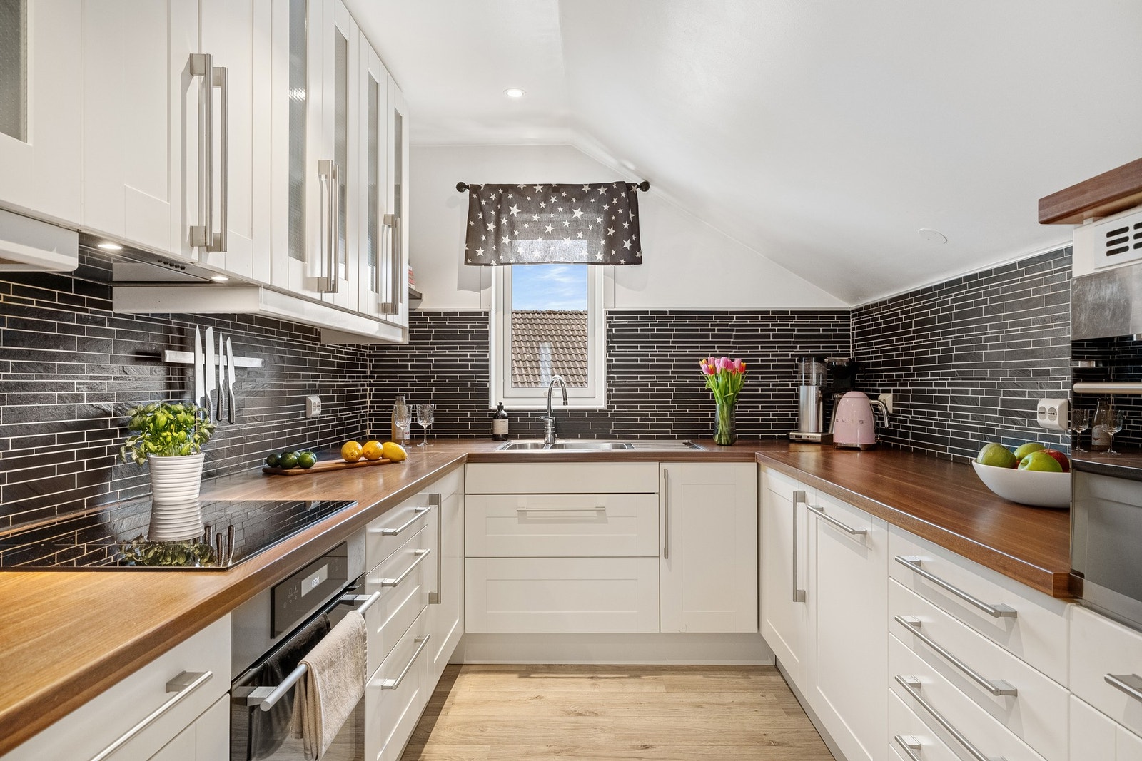 Stilrent kjøkken med rikelig skap- og benkeplass. Galleribilde