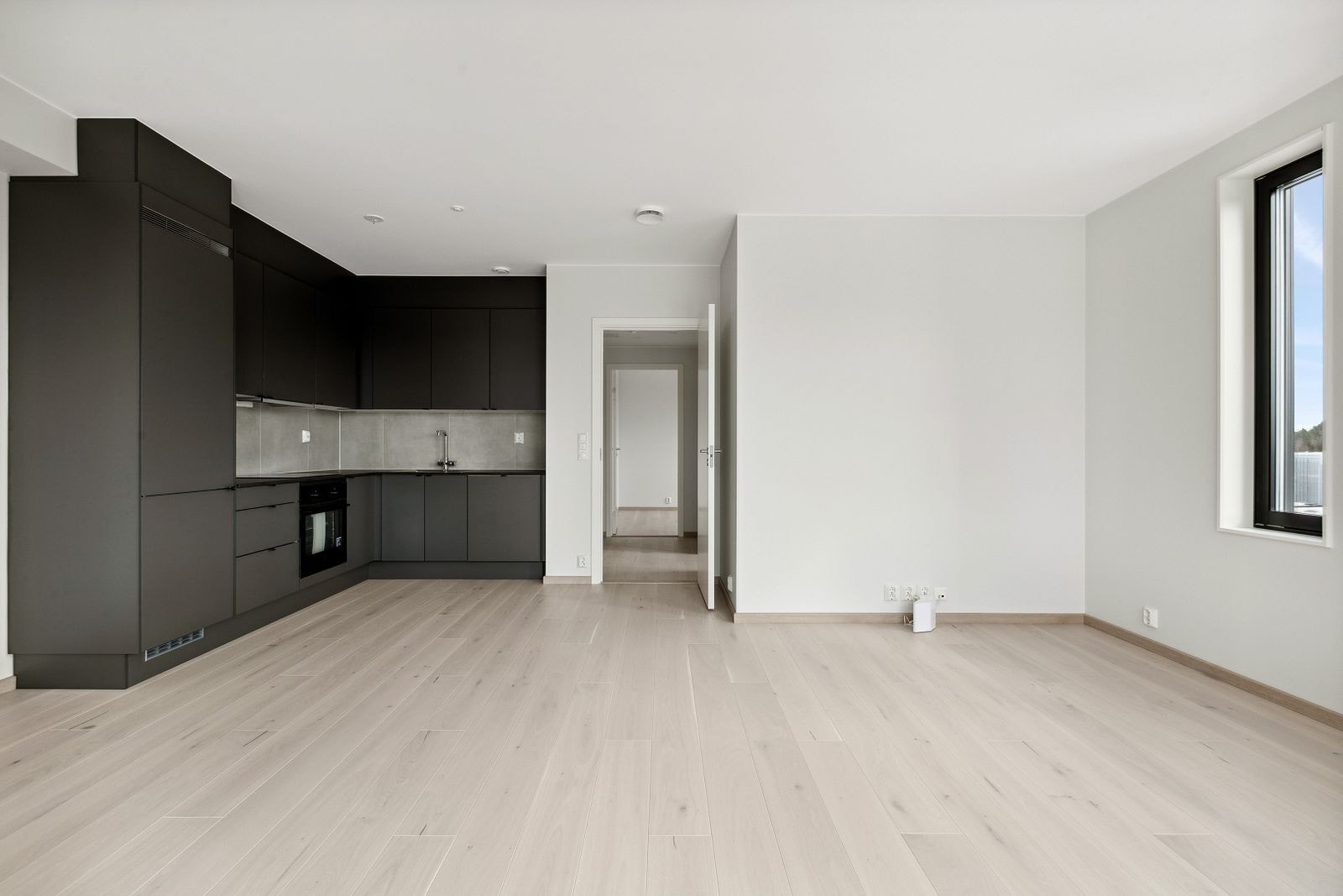 Moderne og åpen stue- og kjøkkenløsning. Kjøkkenet innehar integrerte hvitevarer. Galleribilde