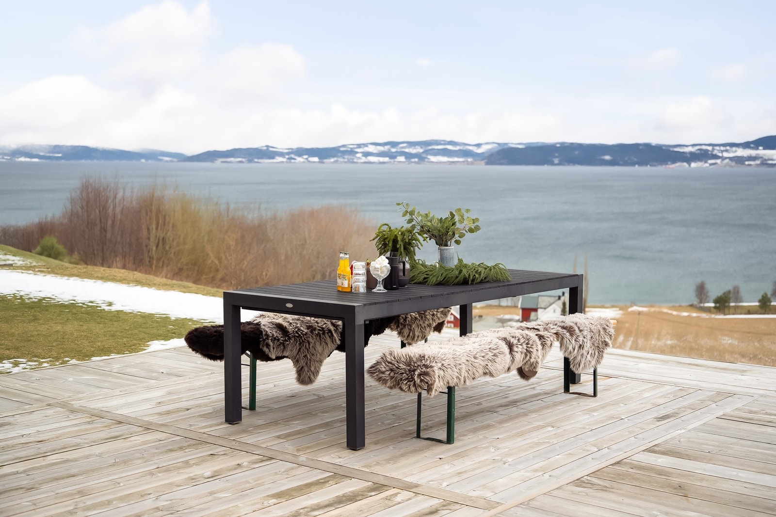 På fremsiden av huset har man en stor terrasse og flat, bruksvennlig hage. Galleribilde