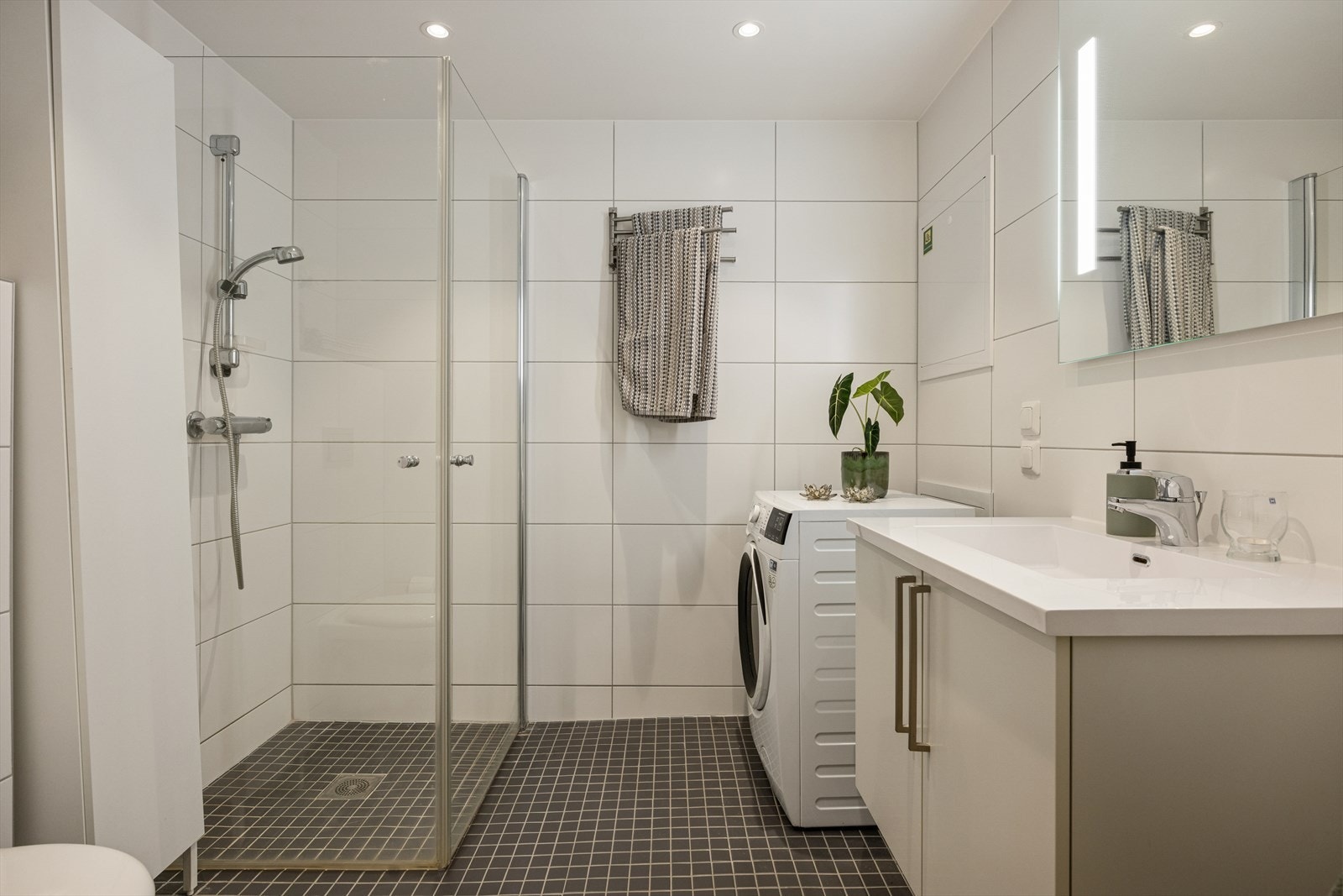 Flislagt baderom som er tilkoblet mekanisk avtrekk via balansert luftagregat, tilluft via luftespalte mellom dørblad og dørterskel. Galleribilde