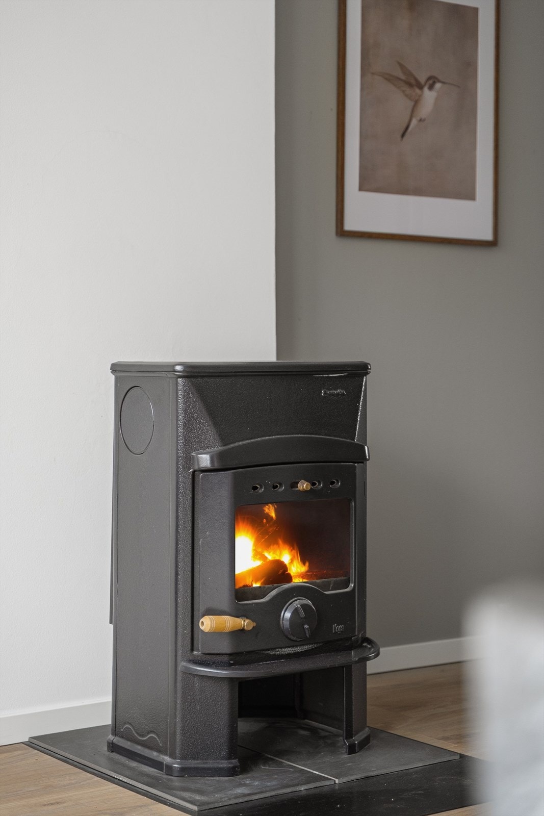 Peis-ovnen er plassert sentralt i rommet og byr på stemningsskapende varme når du tenner opp på kjølige dager. Galleribilde