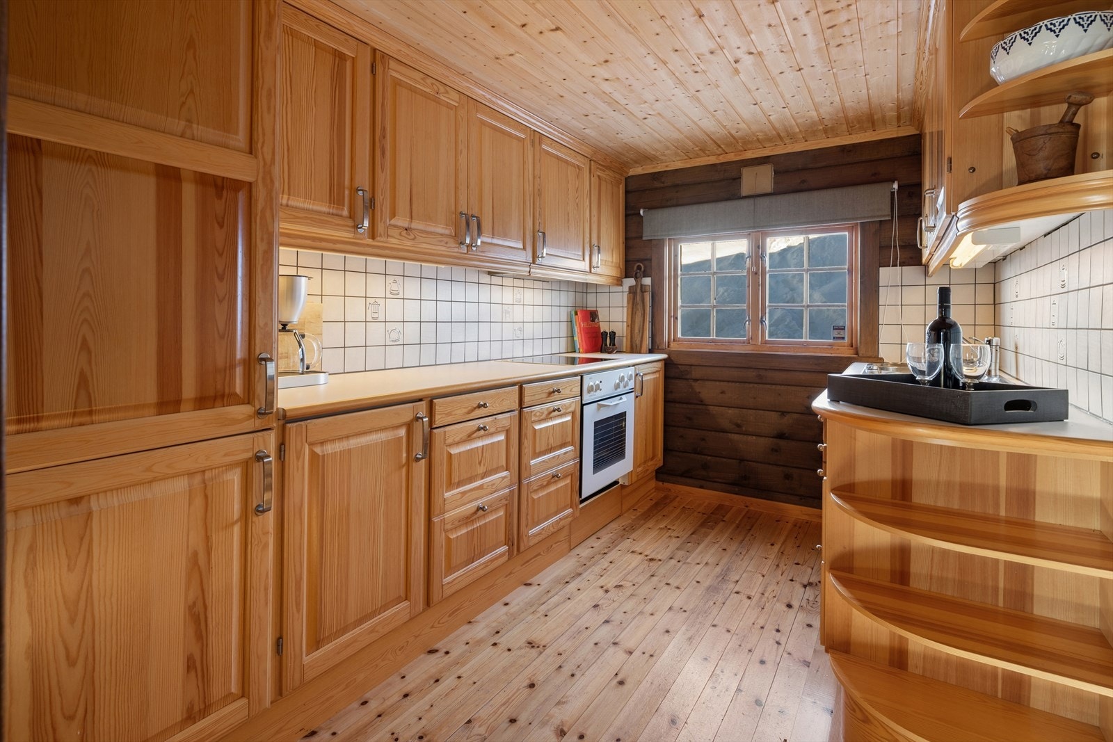 Kjøkkenet har en klassisk innredning i tre, med rikelig skap- og benkeplass. Galleribilde