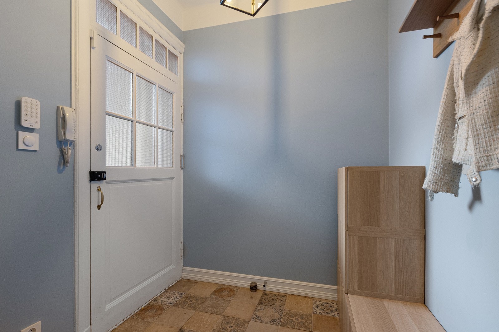 Velkommen inn! Innbydende entré med flislagt gulv, som gir et godt førsteinntrykk av denne fine leiligheten. Galleribilde