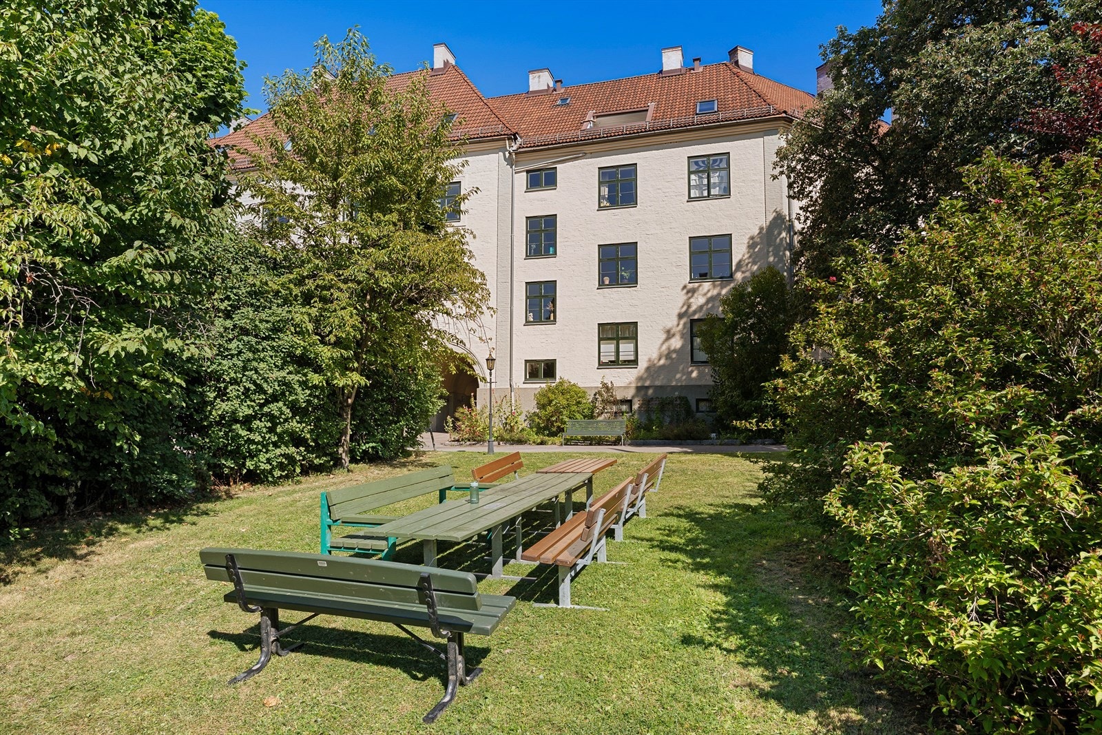 Bakgårdshagen har flere soner med hyggelige sittegrupper i frodige omgivelser Galleribilde