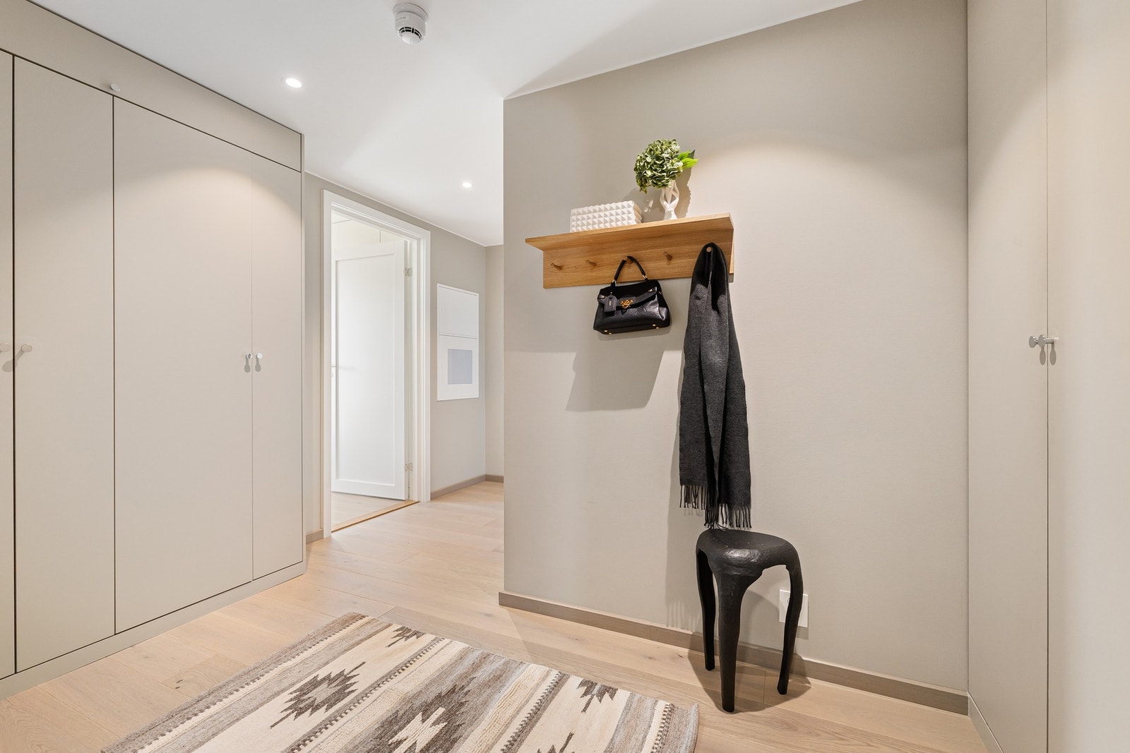 I entréen er det plassbygde skap med rikelig oppbevaringsplass, som er malt i samme lyse tone som veggene, noe som gir et helhetlig uttrykk. Galleribilde