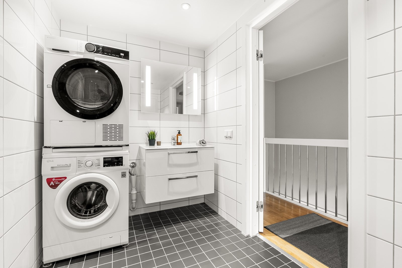 Pent baderom (prefabrikkert våtromskabin) fra byggeår med vannbåren gulvvarme. Rommet har baderomsinnredning med glatte folierte fronter, heldekkende servant og speil med integrert belysning på vegg over servant. Galleribilde