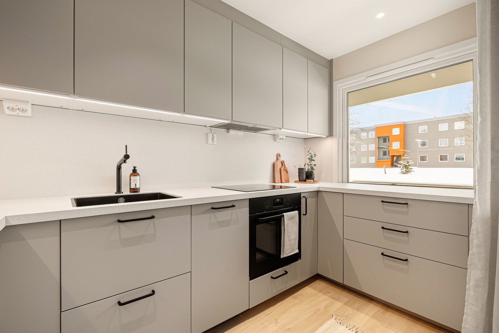 Kjøkkenet er innredet med glatte fronter, downlights i taket og benkeplate av laminat. Integrerte hvitevarer består av komfyr, kjøl/fryseskap og oppvaskmaskin. Galleribilde