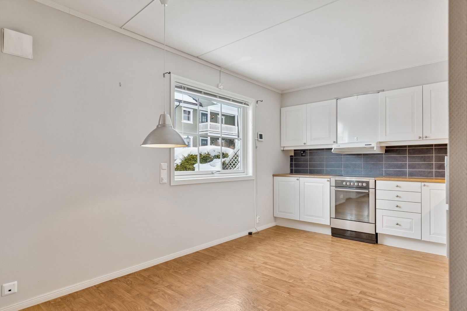 Kjøkken med fin plass for spiseplass ved vinduet. Galleribilde